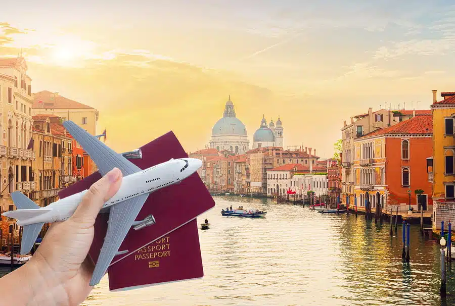 Plane Travel Concept, Hand Holding Passports With Plane Against